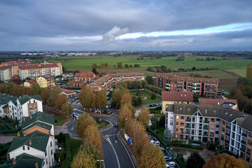 Aerial view of Turin. Little district of Turin Torino in bright autumn day. Orange trees, buildings, roads and cars.