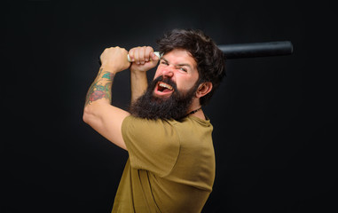 Baseball player with baseball bat. Angry man in t-shirt ready to swing. Sports and baseball training. Sport equipment. Sport, training, health. Power and energy concept. Bearded man with baseball bat.
