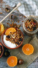 Bowls with white yogurt, granola and citruses. Granola and honey. Healthy breakfast. Keto diet. Flat lay. Selective focus.