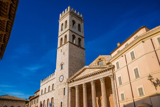 Medieval People's Tower and ancient roman Temple of Minerva in Assisi Communal Square, in the city historic center