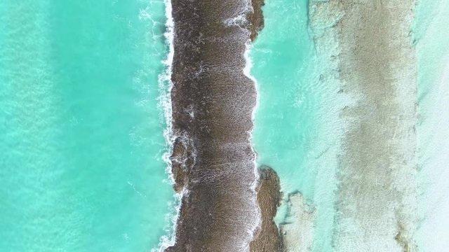 Top-down aerial shots of beautiful rock formation and beaches with crystal clear blue water in Esperance, Western Australia.
