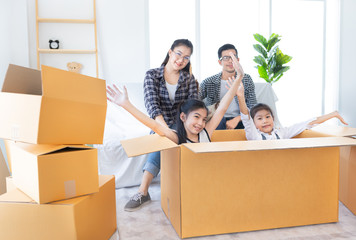 asian family packing and unpacking paper box together, they will decorating and cleaning home, they feeling happy in family time, they move to a new residence