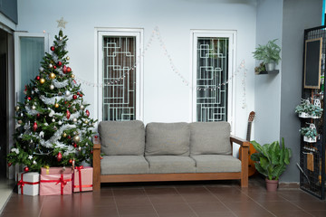 livingroom interior with christmas tree and gift box