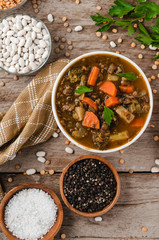 Healthy vegetable soup on a barn board background
