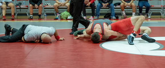 Boy High School wrestlers competing at a wrestling meet