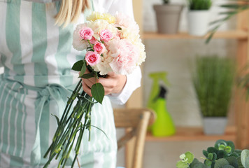Female florist with beautiful bouquet in shop, closeup