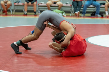 Naklejka premium Boy High School wrestlers competing at a wrestling meet
