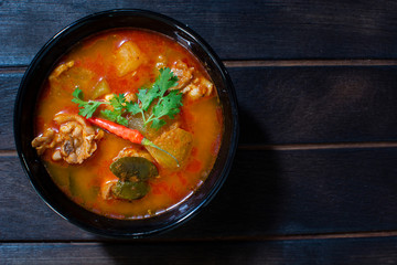 Chicken curry hatching on a black wooden background