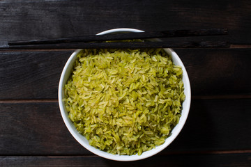 Steamed rice on a black wooden background