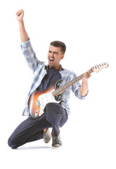 Handsome emotional man playing guitar on white background