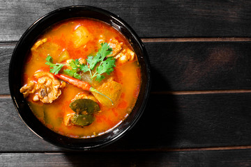 Chicken curry hatched on a dark wooden cup
