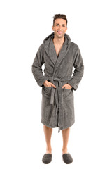 Handsome man in bathrobe on white background
