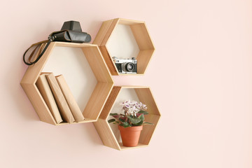 Modern shelves hanging on color wall