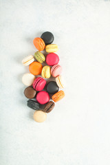 Different macaroons on a light background. Top view