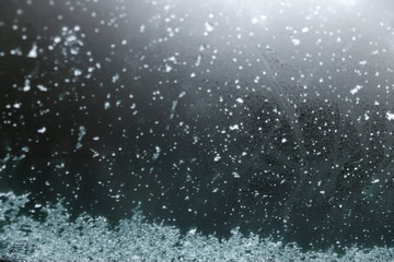 Abstract snow flakes falling on the car window