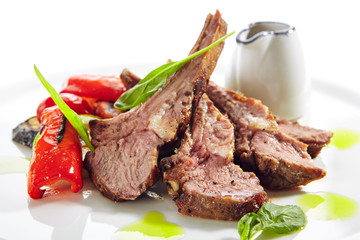 Grilled Lamb Rack with Baked Vegetables on White Restaurant Plate