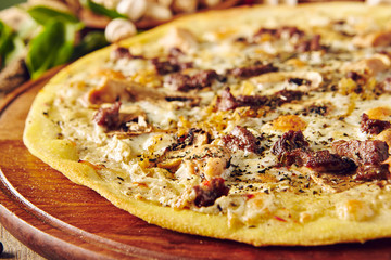 Mushroom pizza on wooden table close up