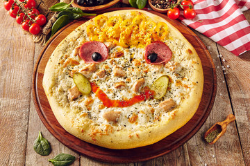 Pizza for children on wooden table closeup