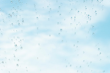 Raindrop water dew drop on glass wet white gray blue background.