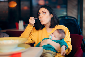 Obraz premium Mom Eating Holding Sleeping Baby at the Table