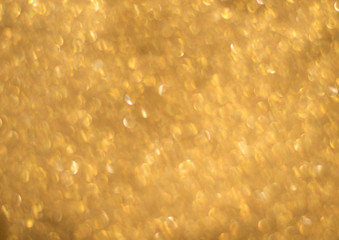 Abstract gold shiny Christmas background. Background for holiday cards. Blur, bokeh.