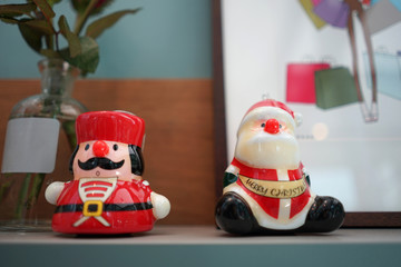 Christmas decorative small ceramic doll on timber table