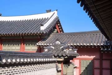 Fototapeta na wymiar Korean traditional tiled roof and stone wall, ancient architecture of palace .