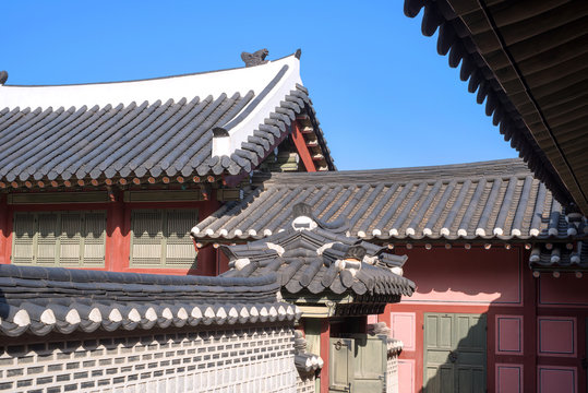 Korean traditional tiled roof and stone wall, ancient architecture of palace .