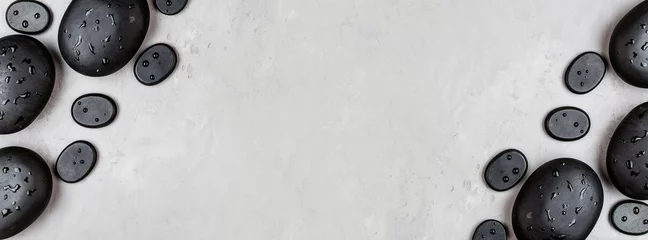 Deurstickers Bovenaanzicht van hot spa-stenen voor massagebehandeling op grijze betonnen achtergrond met kopieerruimte. Elegante en luxe spa. Plat leggen, overhead, mock-up, sjabloon. Gezondheids- en schoonheidsverzorgingsconcept © Алина Бузунова