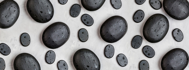 Top view of hot spa stones set for massage treatment on gray concrete background. Elegant and luxury spa. Flat lay, overhead, mock up, template. Health and beauty care concept