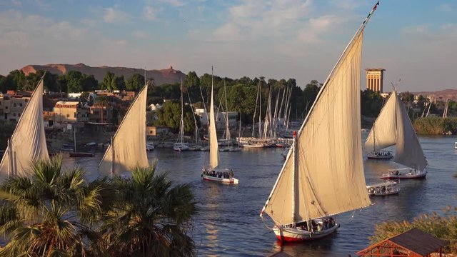 Beautiful landscape with felucca boats on Nile river in Aswan at sunset, Egypt, 4k