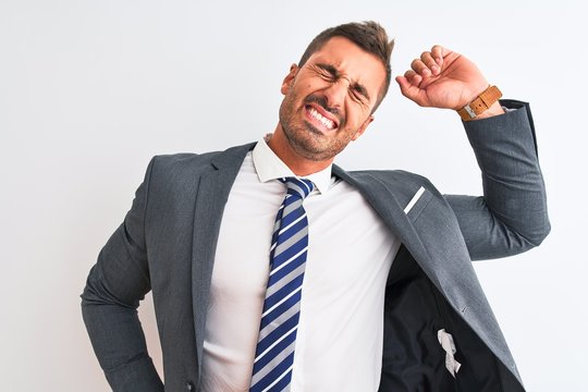 Young handsome business man wearing suit and tie over isolated background stretching back, tired and relaxed, sleepy and yawning for early morning