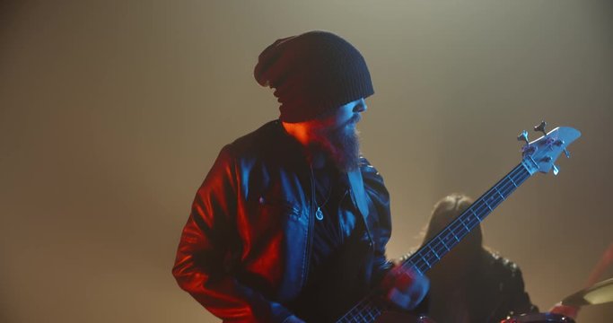 Rock duet performing. Professional guitarist and drummer rocking the party up in club, playing coll rock, punk or metal music 4k footage