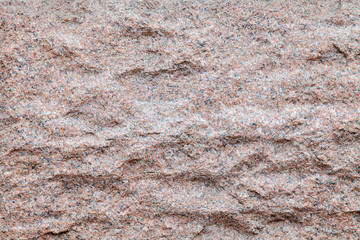 Background and texture of a granite wavy wall in a rock of a mountain for decor and interior decoration. Design and patterns.