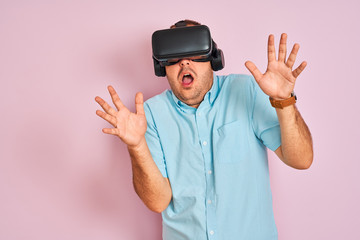Young plus size man playing virtual reality game using goggles