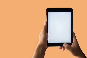 Mockup image of hand holding white mobile phone with blank white CIL orange cantaloupe background.