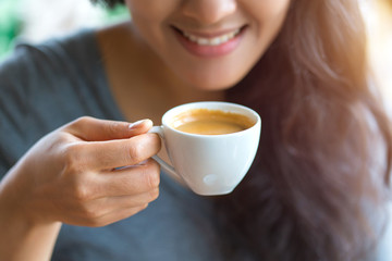 woman drinking espresso at coffee cafe - 307057359