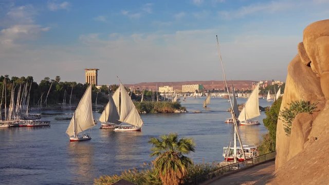 Beautiful landscape with felucca boats on Nile river in Aswan at sunset, Egypt, 4k