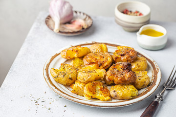 Homemade baked smashed baby potatoes with garlic, salt and herbs