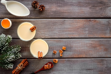 Make festive drink eggnog - ingredients on dark wooden background top view frame copy space