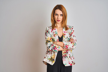 Young caucasian business woman wearing spring floral jacket suit over isolated background skeptic and nervous, disapproving expression on face with crossed arms. Negative person.
