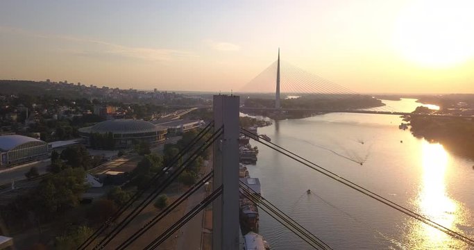 Aerial view of Ada suspension bridge and old railway bridge in Belgrade during sunset