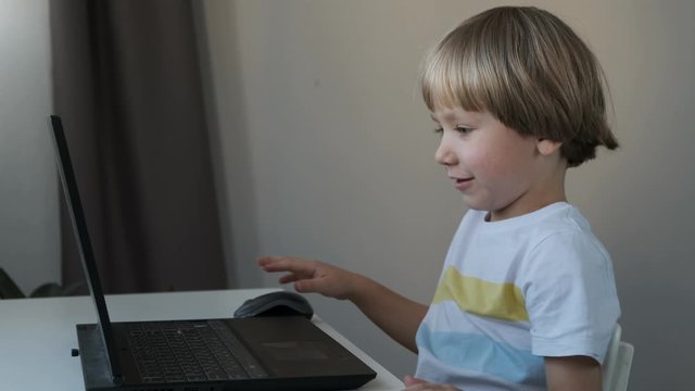 Boy working on a computer, programming, learning or playing