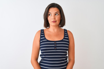 Fototapeta premium Young beautiful woman wearing blue striped t-shirt standing over isolated white background smiling looking to the side and staring away thinking.
