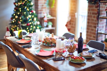 Nice home with tree, decorations and table with food prepared to celebrate Christmas