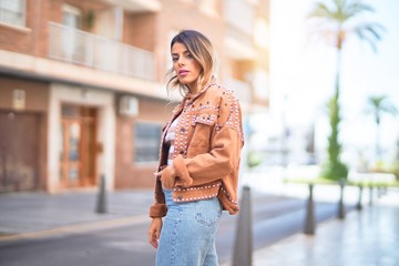 Fototapeta premium Young beautiful woman smiling happy and confident. Standing and walking at town street