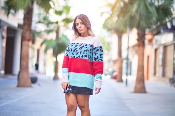 Young beautiful woman smiling happy and confident. Standing and walking at town street