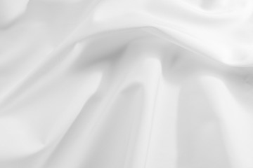 Obraz premium Abstract white fabric texture background. Cloth soft wave. Creases of satin, silk, and cotton.