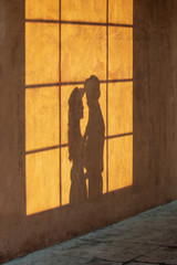 Shadow of lover with woman and man at vintage window mirror.