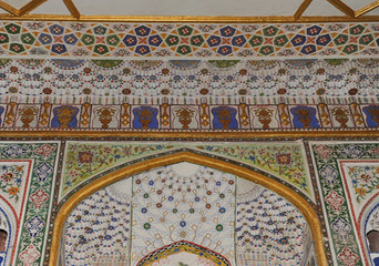 The ceiling in the form of a dome in a traditional ancient Asian mosaic. The details of the architecture of medieval Central Asia